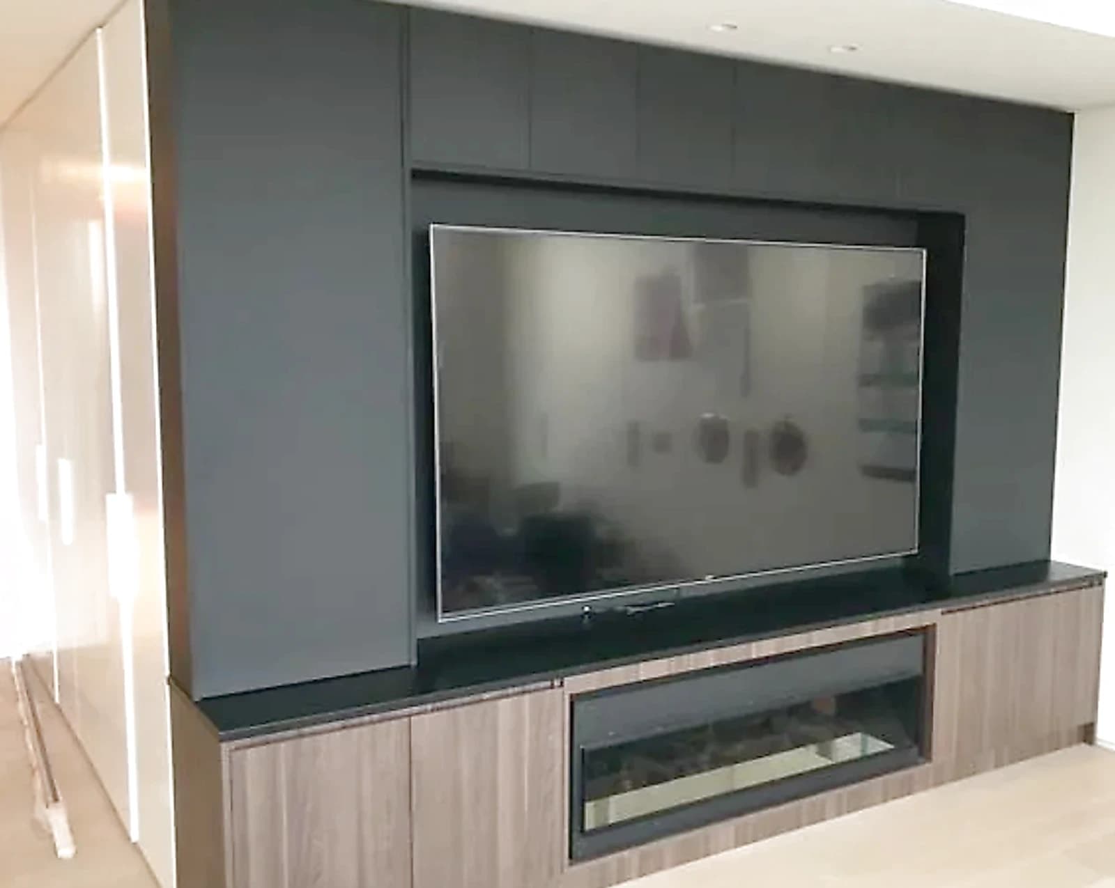 Custom entertainment wall joinery with storage and display shelving, by H&R Kitchens